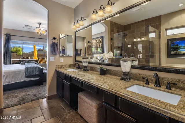 a bedroom with a large bed and a chandelier