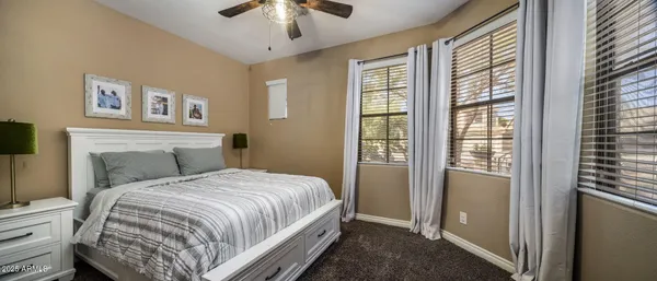 a view of a patio with a table chairs and a floor to ceiling window