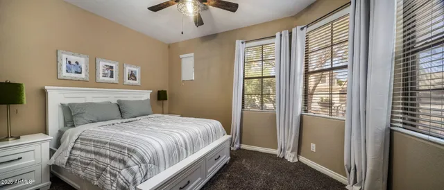 a view of a patio with a table chairs and a floor to ceiling window