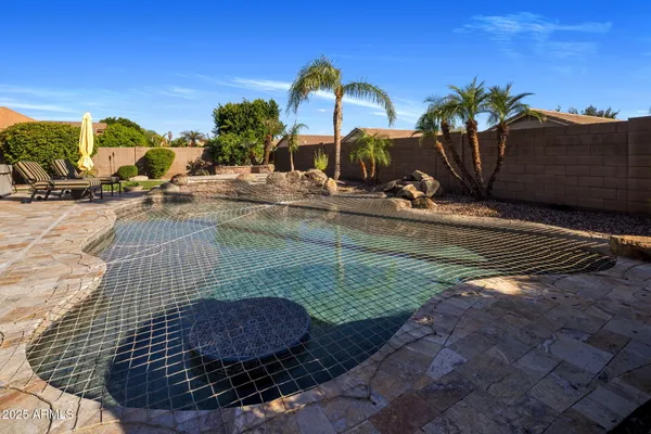 a view of a swimming pool with a table and chairs
