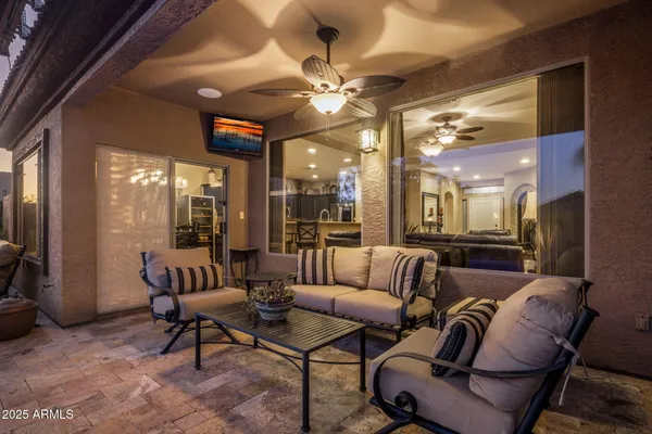 a view of a house with swimming pool and sitting area