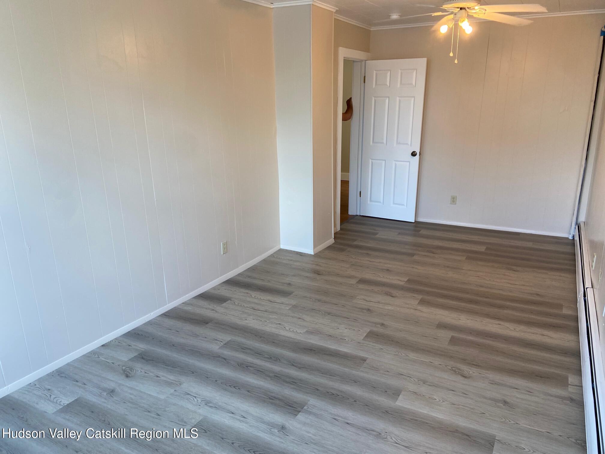 214 Robinson Street, Unit 2 Hudson, NY 12534 - Photo 7 of 13 a view of an empty room with wooden floor