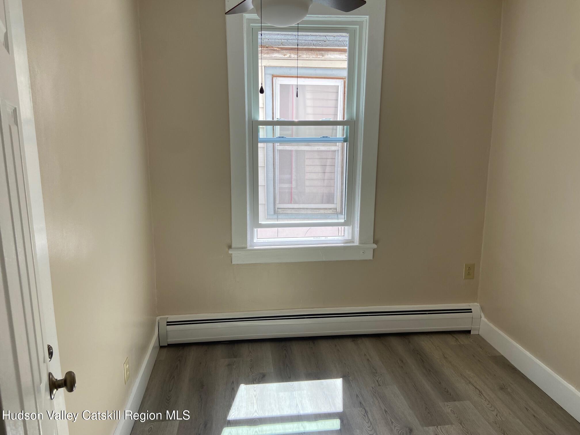 214 Robinson Street, Unit 2 Hudson, NY 12534 - Photo 10 of 13 a view of a small space with wooden floor and a window