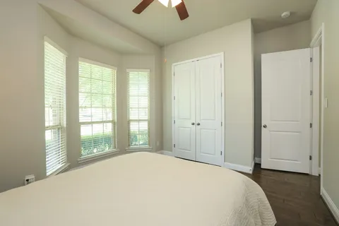 a spacious bathroom with a granite countertop tub sink and mirror
