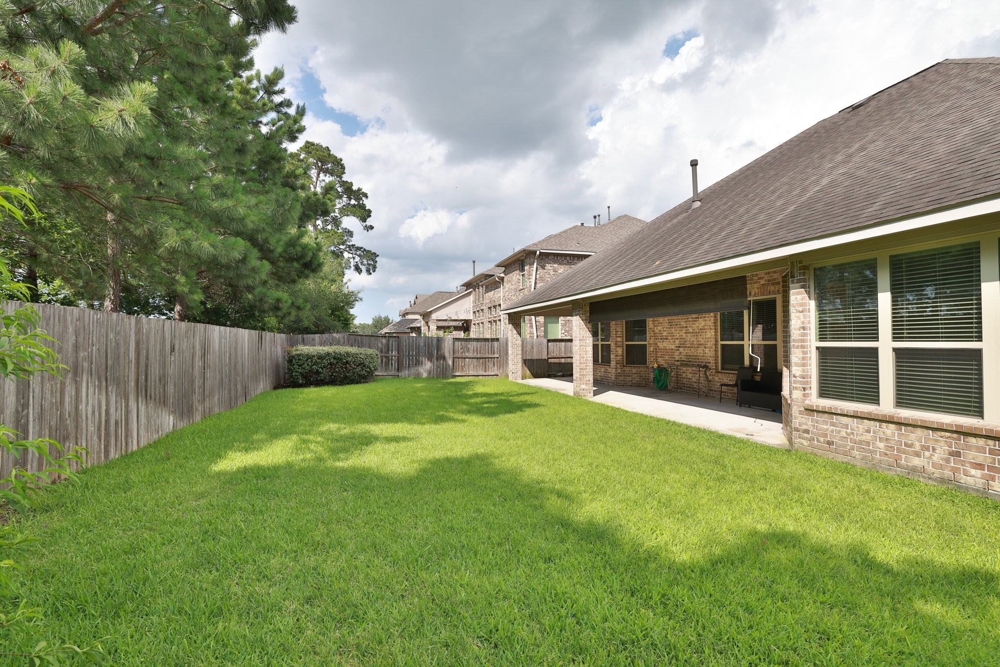 9935 Kirkstone Terrace Drive Spring, TX 77379 - Photo 42 of 49 Low maintenance backyard with wood fence and brick fence behind that.