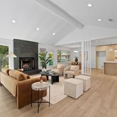 a living room with fireplace furniture and a large window