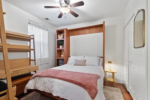 a bedroom with a bed and a chandelier