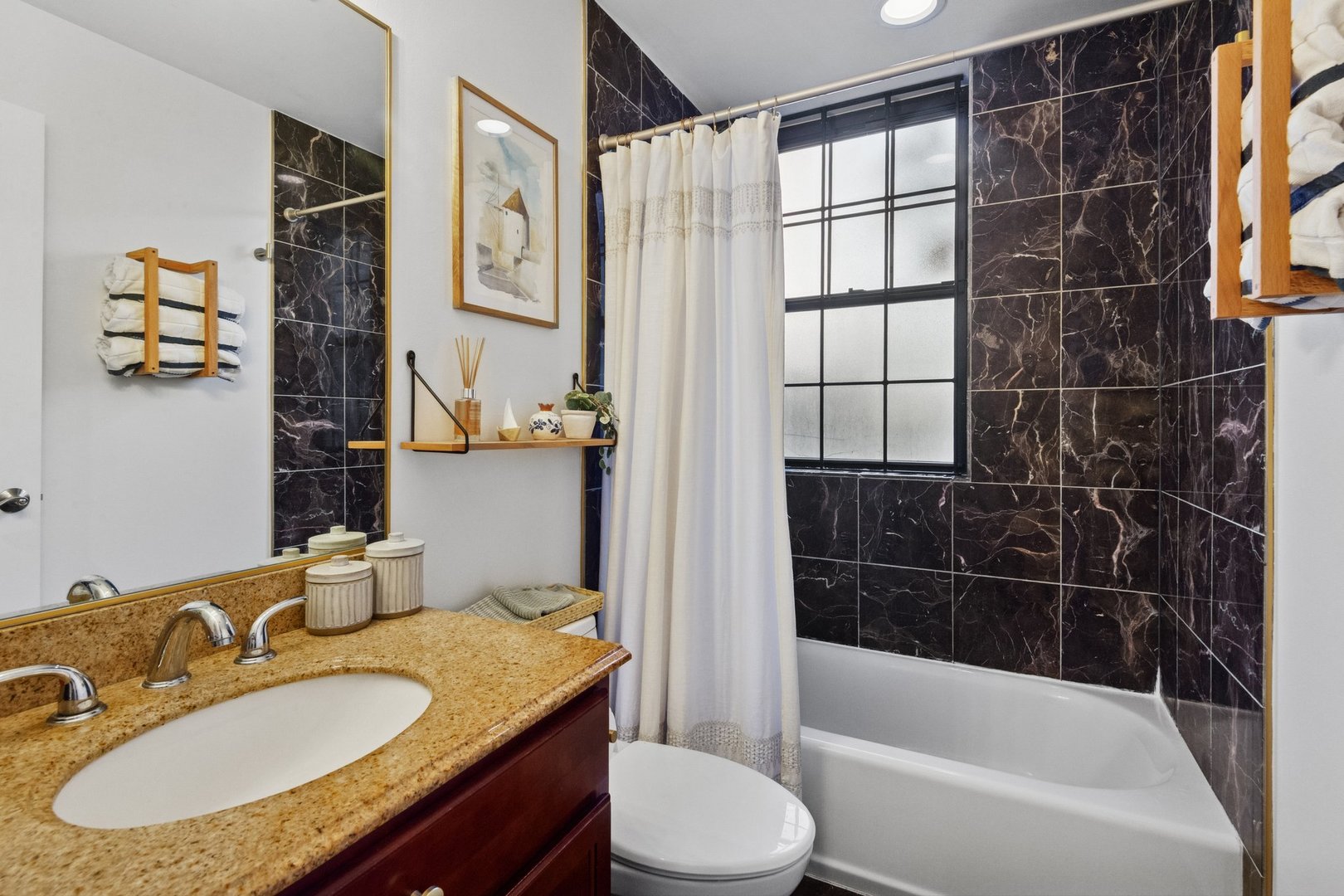 2314 Sherman Avenue, Unit G Evanston, IL 60201 - Photo 13 of 15 a bathroom with a granite countertop sink a mirror a bathtub and shower