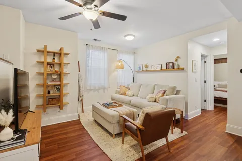 a living room with furniture a flat screen tv and a rug