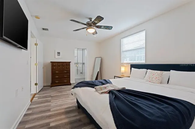 a bedroom with a bed and a flat screen tv