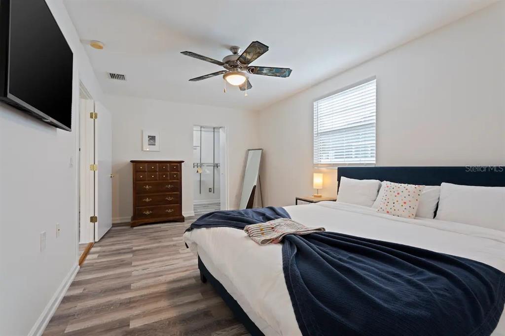 1411 Gray Street South Gulfport, FL 33707 - Photo 11 of 25 a bedroom with a bed and a flat screen tv