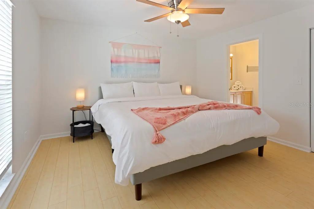 1411 Gray Street South Gulfport, FL 33707 - Photo 12 of 25 a bedroom with a bed and a chandelier