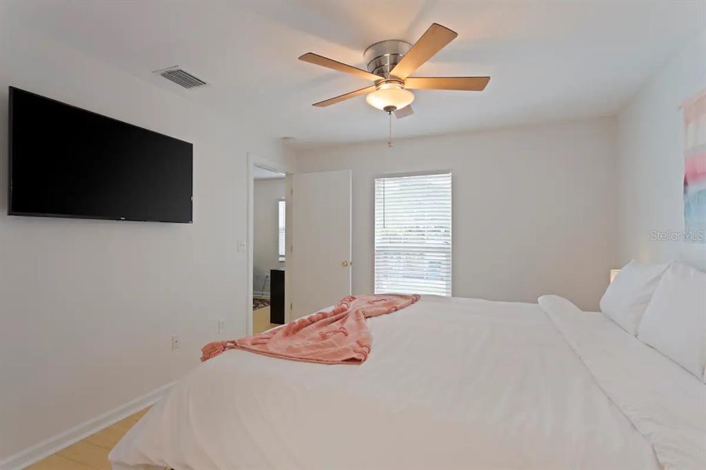 1411 Gray Street South Gulfport, FL 33707 - Photo 13 of 25 a bedroom with a large bed and a flat screen tv