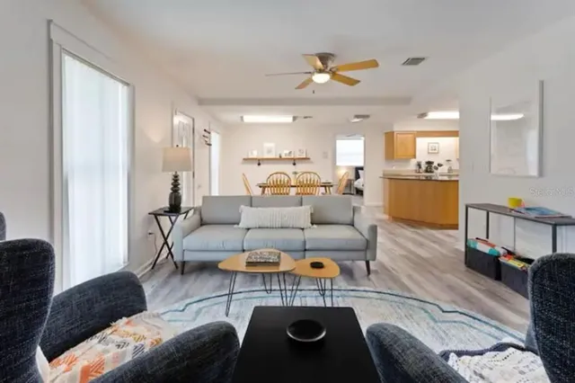 a living room with furniture and a chandelier