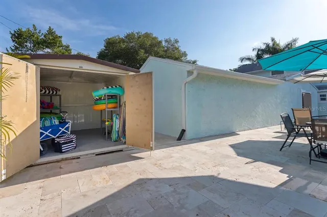 a backyard of a house with table and chairs