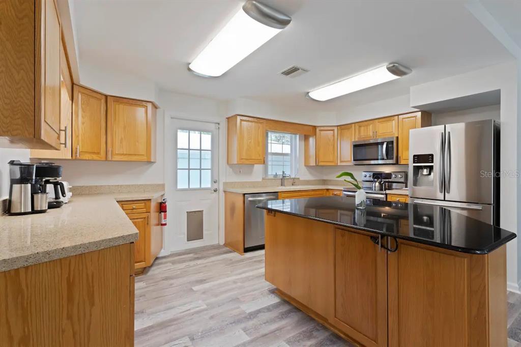 1411 Gray Street South Gulfport, FL 33707 - Photo 7 of 25 a kitchen with stainless steel appliances granite countertop a sink stove and refrigerator