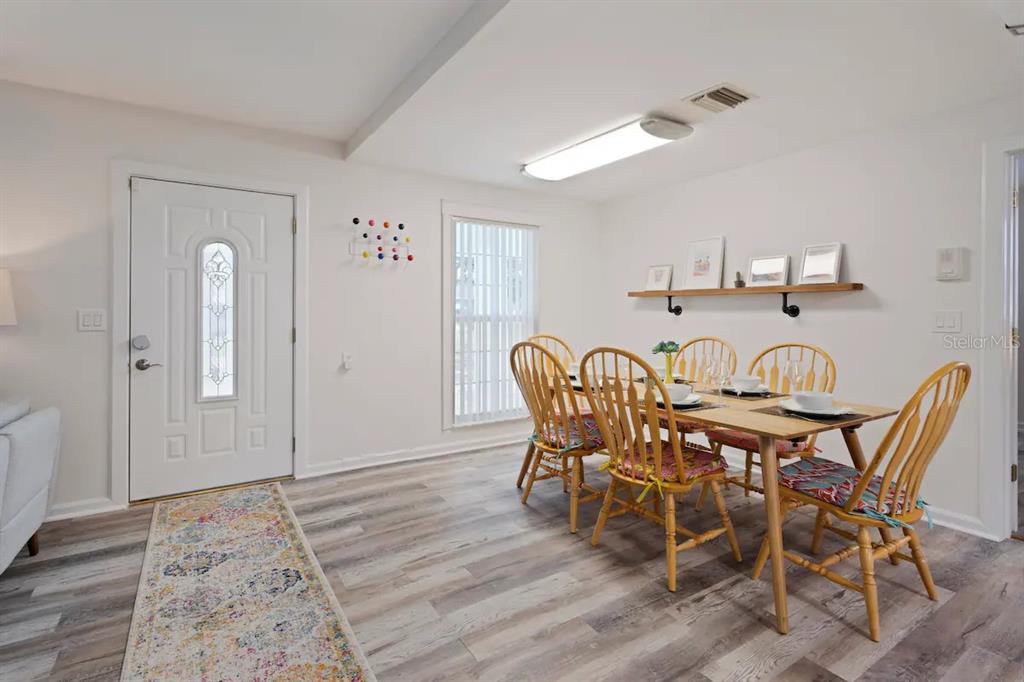 1411 Gray Street South Gulfport, FL 33707 - Photo 9 of 25 a view of a dining room with furniture and wooden floor