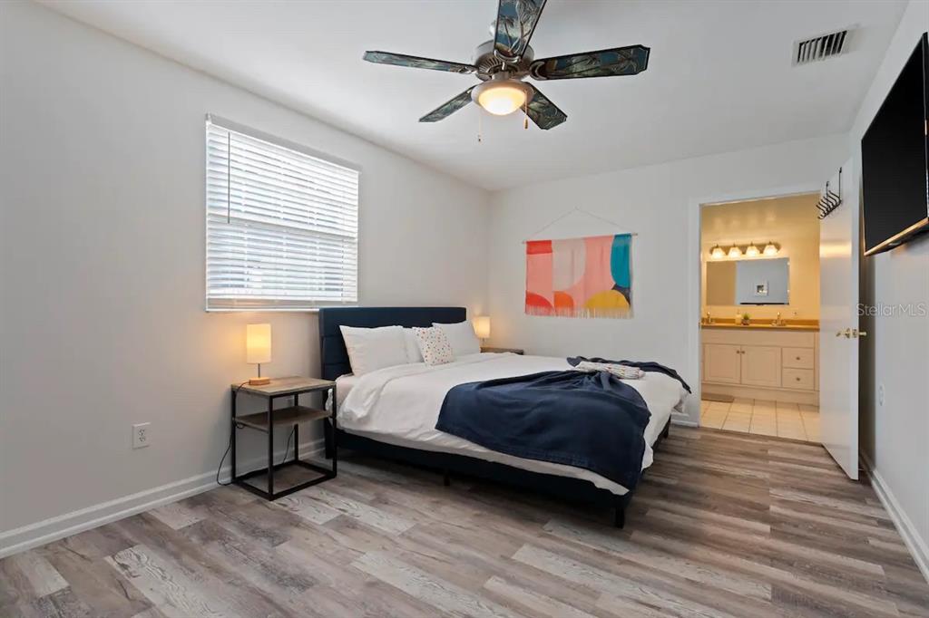 1411 Gray Street South Gulfport, FL 33707 - Photo 10 of 25 a bedroom with a bed and a chandelier