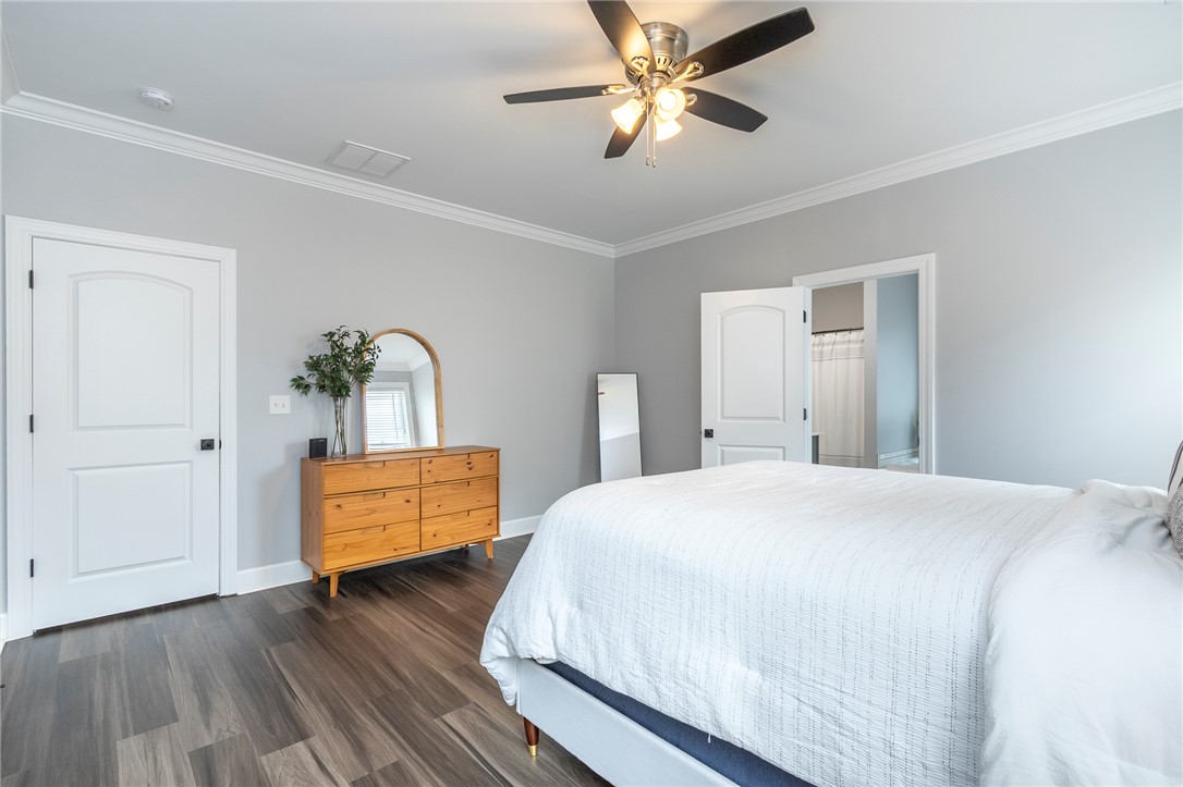 3080 McGee Road Iva, SC 29655 - Photo 30 of 49 Hardwood floors and crown molding elevate this restful sleeping area.