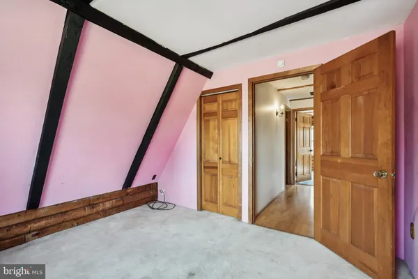 a view of an empty room with an empty space and windows