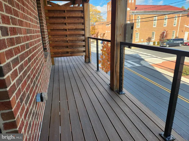 a view of balcony with wooden floor