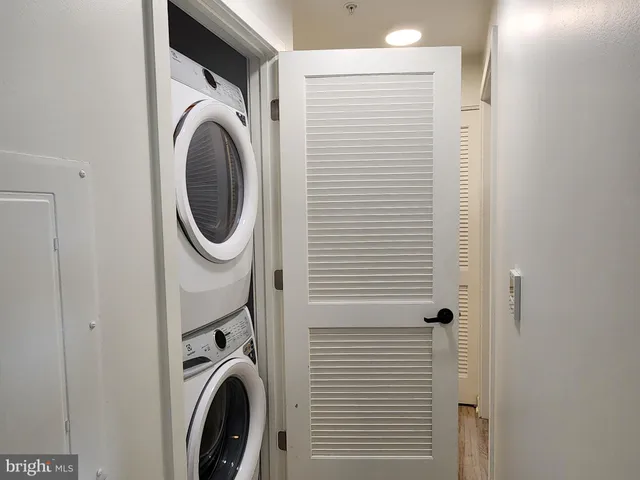 a view of a hallway with washer and dryer