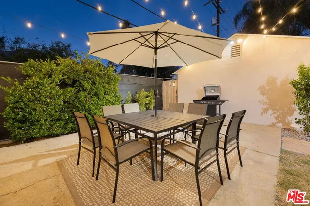 a view of a backyard with furniture and a table
