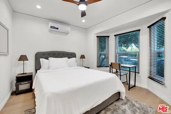 a bedroom with a large bed and a large window