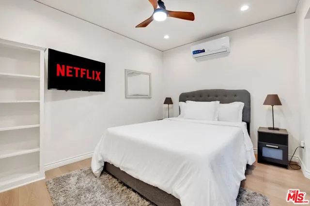 a bedroom with a bed and a flat screen tv