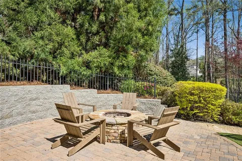 a view of backyard with swimming pool and patio