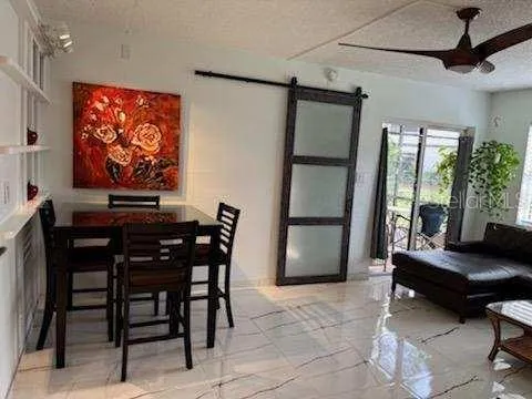 a view of a livingroom with furniture and a window