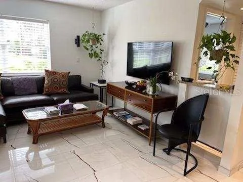 a living room with furniture and a potted plant