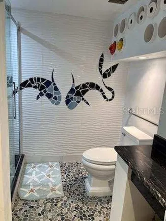 a bathroom with a toilet and a shower