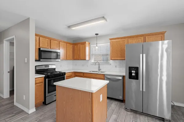 a kitchen with stainless steel appliances a refrigerator stove and sink
