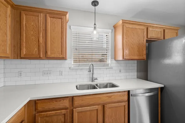 a kitchen with a sink cabinets and window