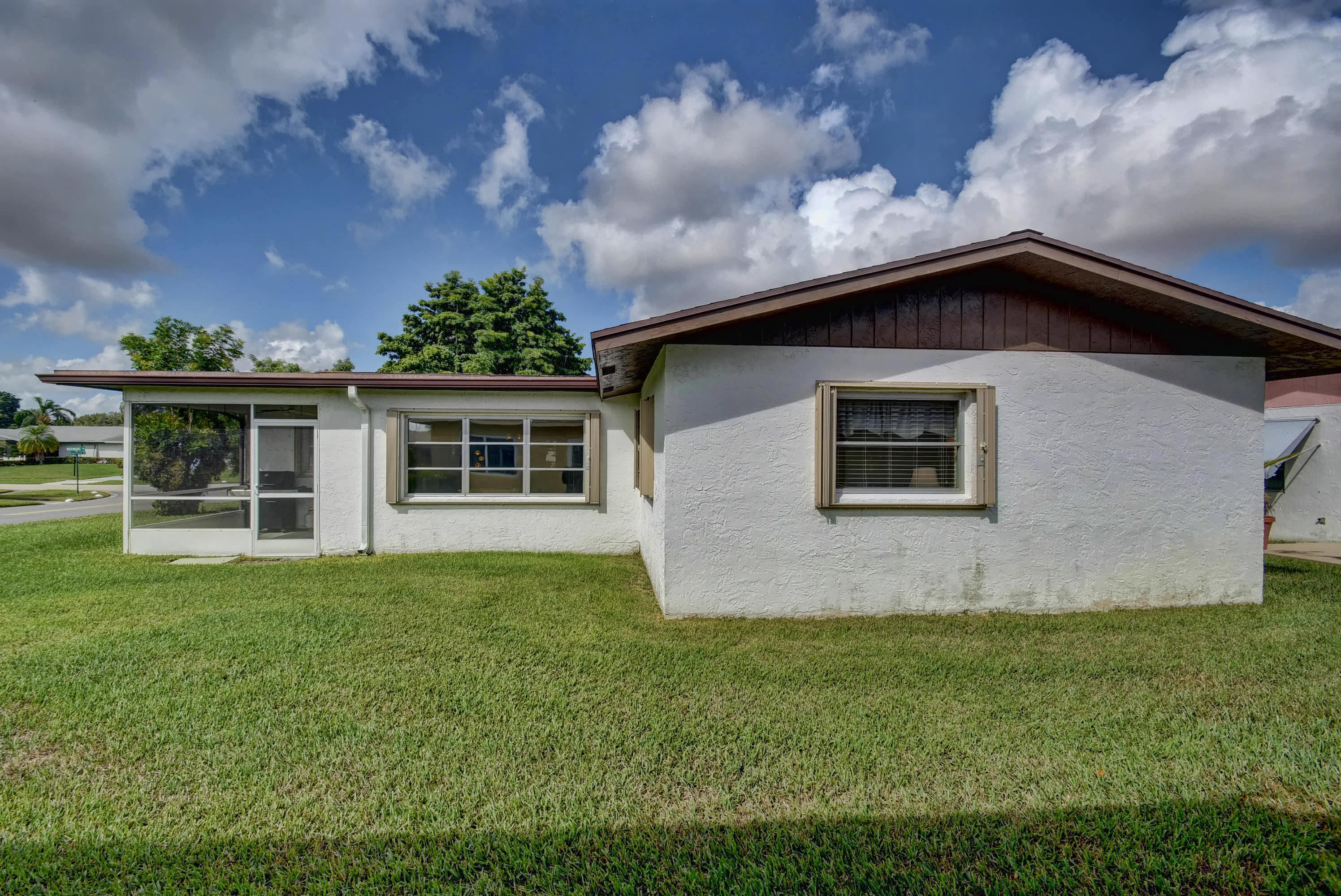 6295 Dusenburg Road Delray Beach, FL 33484 - Photo 33 of 34 a front view of a house with a garden