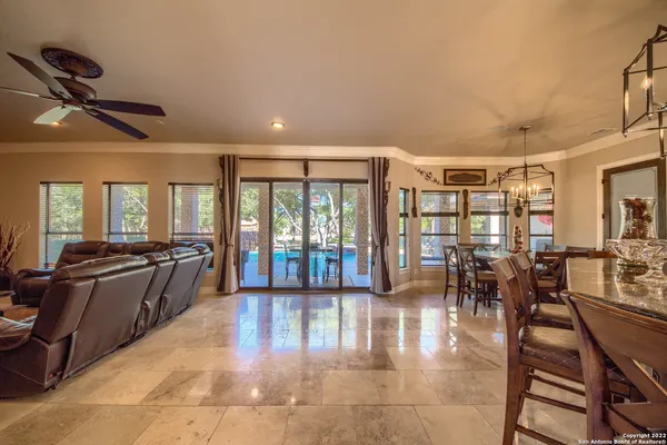 a dining room with furniture a chandelier and wooden floor