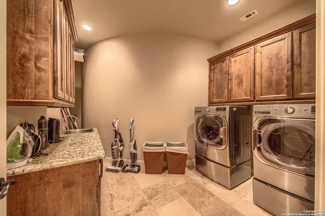 a kitchen with stainless steel appliances granite countertop a stove and a sink