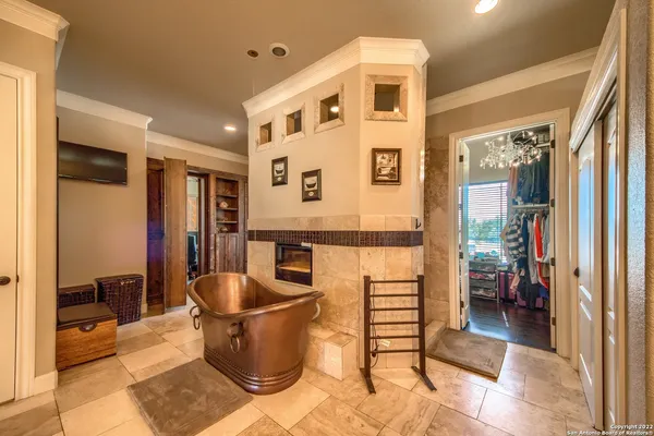 a bedroom with a large bed and a tv