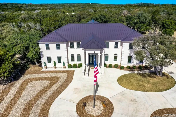 a view of a house with swimming pool and sitting area