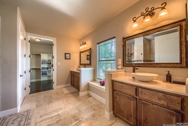 a bedroom that has a bed and a chandelier