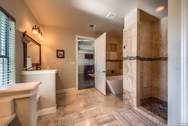 a en suite bathroom with a double vanity sink a mirror and a shower