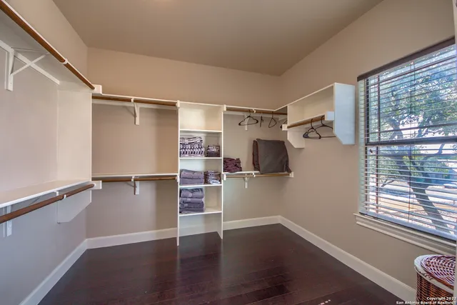 a view of walk in closet with clothes