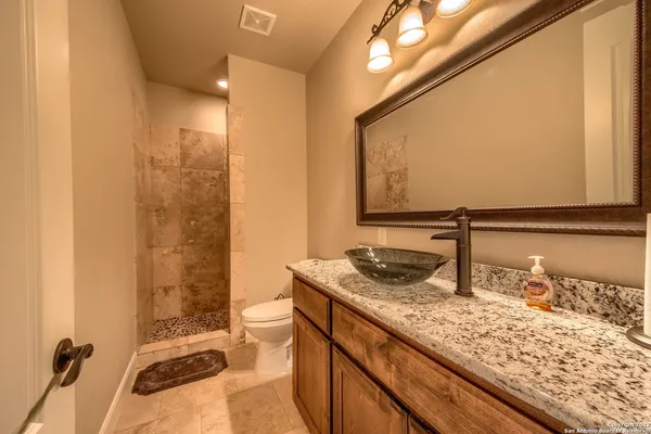 a living room with stainless steel appliances kitchen island granite countertop furniture and a fireplace