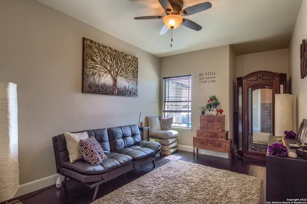 a view of a swimming pool with red chairs