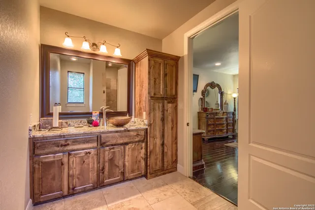 a view of a patio with a table and chairs under an umbrella
