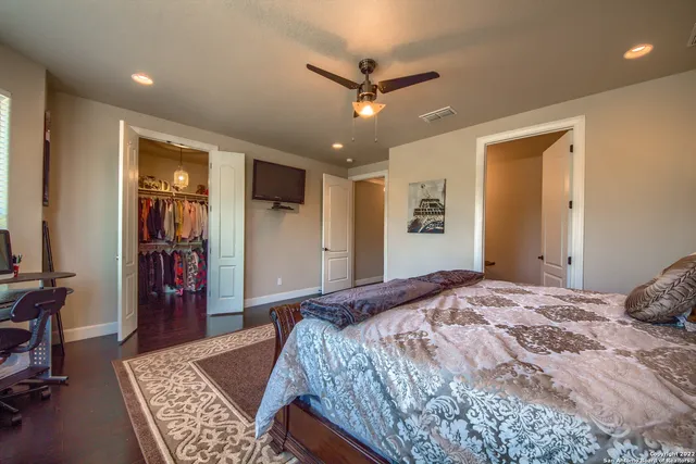 a view of a swimming pool with red chairs