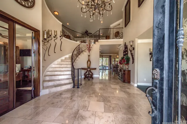 a dining room with furniture a chandelier and window