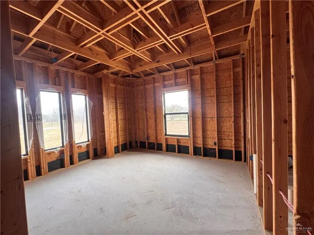 a view of an empty room with windows