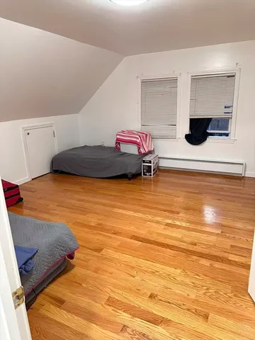 a bedroom with a bed and a night stand